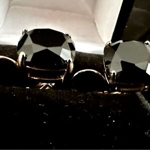 Black stone in yellow gold lever back earrings.